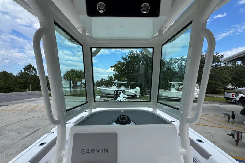 Slide: The Image of 2026 Caymas 28 HB boat interior with Garmin navigation, docked outdoors. - 34