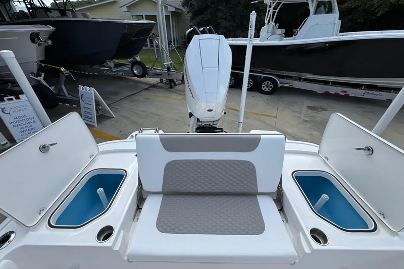 Slide: The Image of 2026 Caymas 28 HB boat with seating and storage compartments, displayed at a marina. - 39