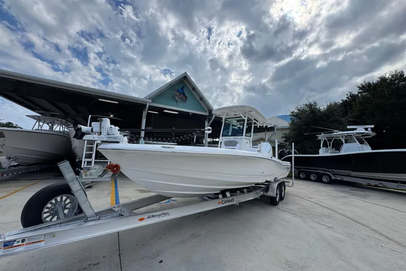Slide: The Image of 2026 Caymas 28 HB boat on trailer, parked outdoors under cloudy sky. - 4