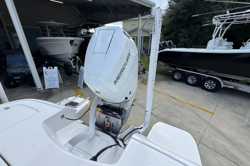 Slide: The Image of 2026 Caymas 28 HB boat with Mercury outboard engine in a showroom. - 40