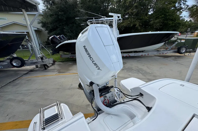 Slide: The Image of 2026 Caymas 28 HB boat with Mercury outboard engine, parked on a trailer. - 41