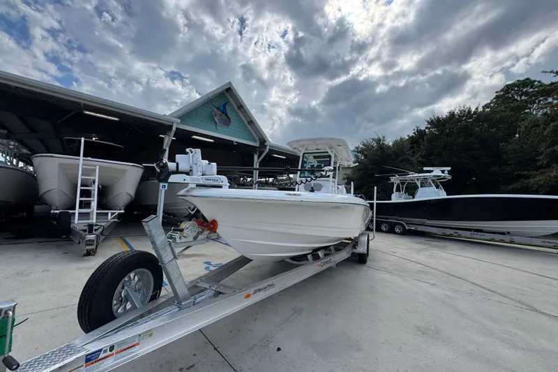 Slide: The Image of 2026 Caymas 28 HB boat on trailer under cloudy sky at marina. - 5