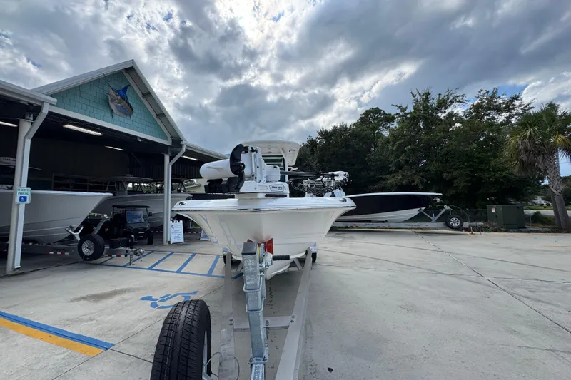 Slide: The Image of 2026 Caymas 28 HB boat on trailer at dealership under cloudy sky. - 7
