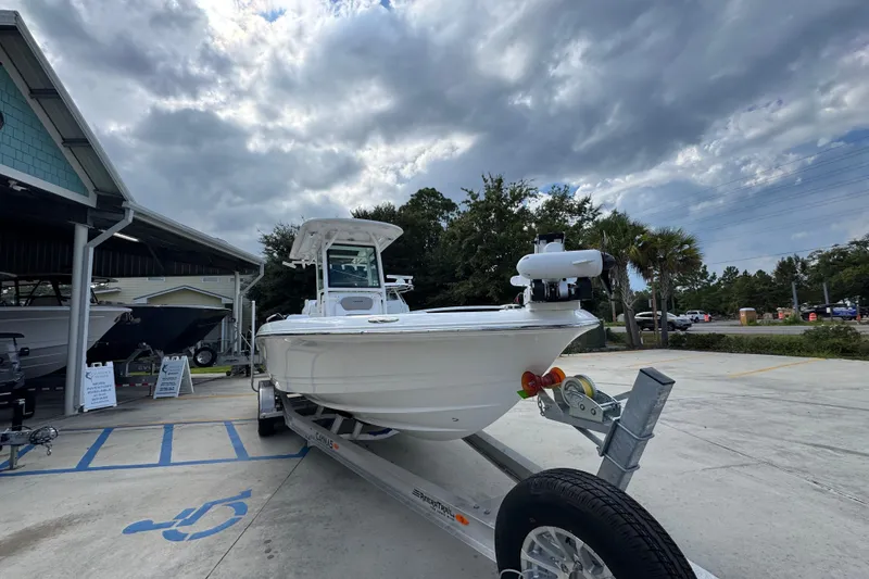 Slide: The Image of 2026 Caymas 28 HB boat on trailer, parked outdoors under cloudy sky. - 8