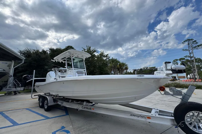 Slide: The Image of 2026 Caymas 28 HB boat on trailer under cloudy sky. - 9