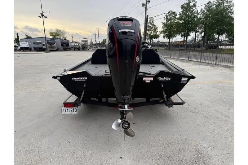 Slide: The Image of 2019 Tracker Pro Team 190 TX boat with Mercury outboard motor, parked in a lot. - 4