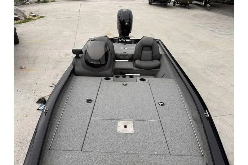Slide: The Image of 2019 Tracker Pro Team 190 TX boat with gray interior and outboard motor. - 5