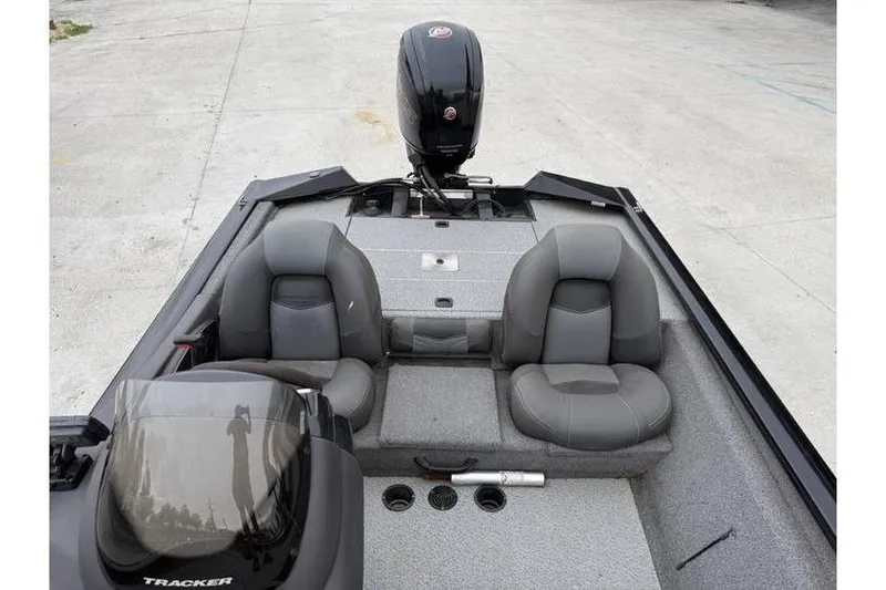 Slide: The Image of 2019 Tracker Pro Team 190 TX boat interior with gray seating and outboard motor. - 6