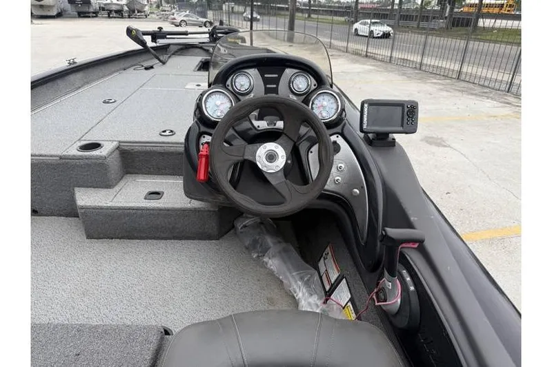 Slide: The Image of 2019 Tracker Pro Team 190 TX boat dashboard with steering wheel and gauges. - 9