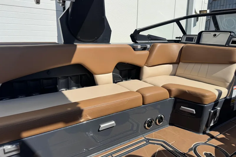 Slide: The Image of 2021 Supra SE 575 boat interior with tan and beige seating, modern design. - 10
