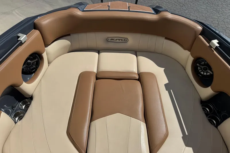 Slide: The Image of 2021 Supra SE 575 boat interior with tan and brown leather seating. - 5