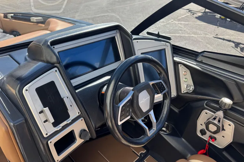 Slide: The Image of 2021 Supra SE 575 boat dashboard with steering wheel and digital displays. - 7