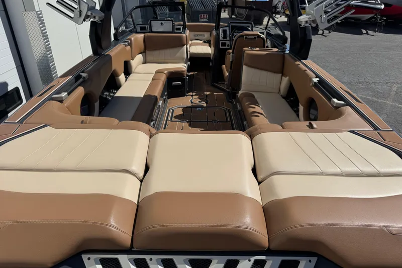 Slide: The Image of 2021 Supra SE 575 boat interior with luxurious tan and cream seating. - 9