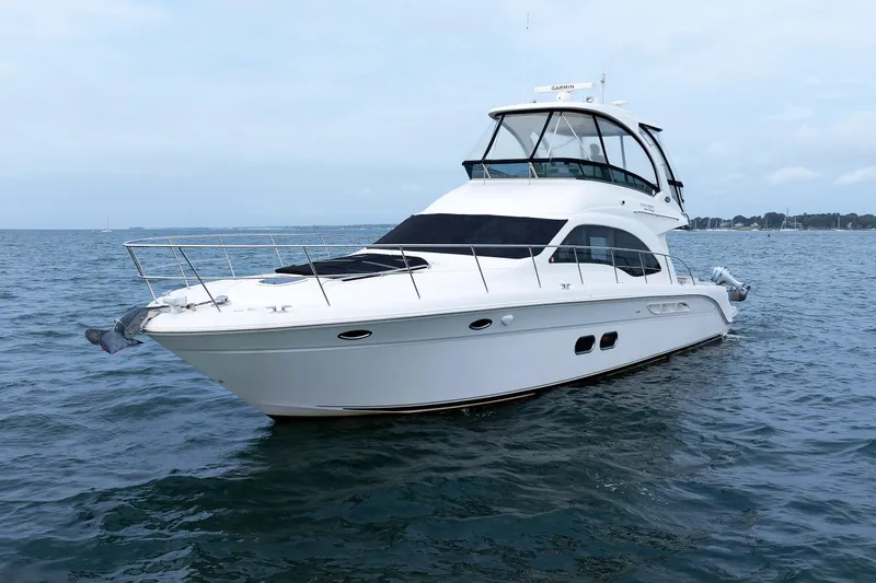 The Image of 2010 Sea Ray 520 Sedan Bridge yacht cruising on open water. - 0
