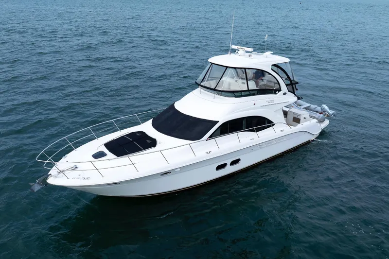 Slide: The Image of 2010 Sea Ray 520 Sedan Bridge yacht cruising on open water. - 10