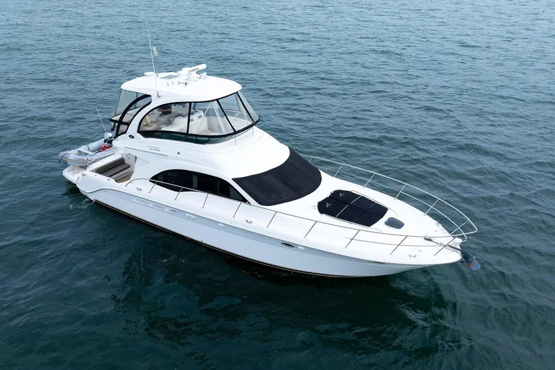 Slide: The Image of 2010 Sea Ray 520 Sedan Bridge yacht cruising on open water. - 13