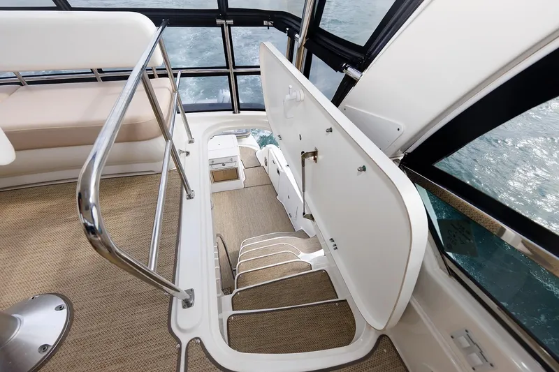 Slide: The Image of Interior view of 2010 Sea Ray 520 Sedan Bridge yacht staircase and seating area. - 17