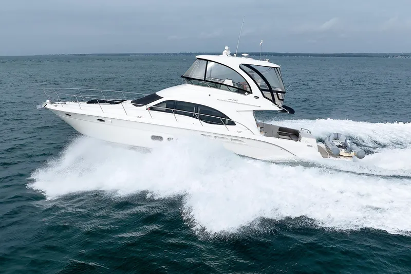 Slide: The Image of 2010 Sea Ray 520 Sedan Bridge yacht cruising on open water. - 2