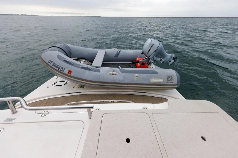 Slide: The Image of 2010 Sea Ray 520 Sedan Bridge with Zodiac inflatable boat on deck. - 28