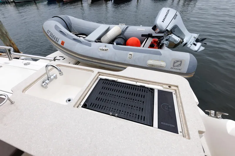 Slide: The Image of Outdoor kitchen on 2010 Sea Ray 520 Sedan Bridge with Zodiac inflatable boat. - 29