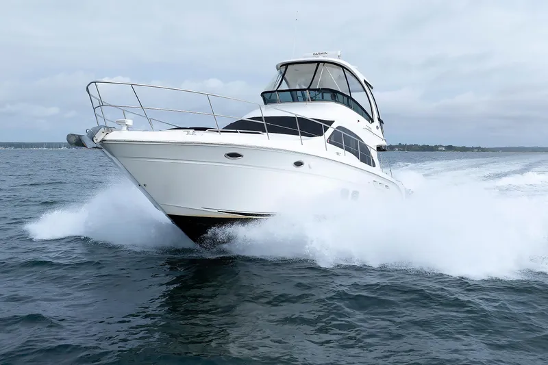 Slide: The Image of 2010 Sea Ray 520 Sedan Bridge yacht cruising on open water. - 3