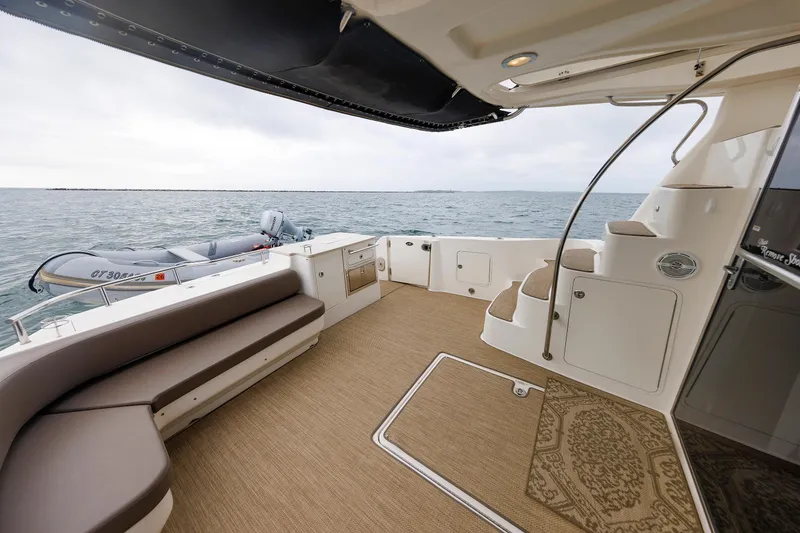 Slide: The Image of 2010 Sea Ray 520 Sedan Bridge yacht deck with seating, overlooking ocean view. - 30