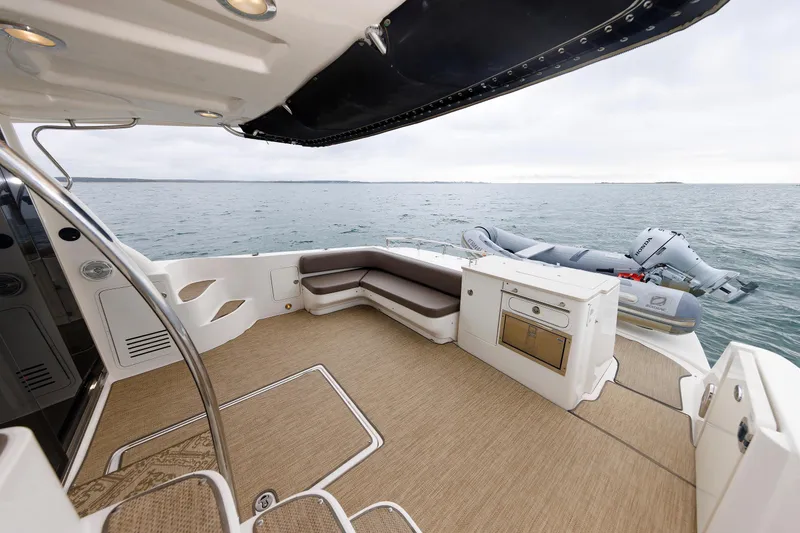 Slide: The Image of 2010 Sea Ray 520 Sedan Bridge yacht deck with seating and ocean view. - 31
