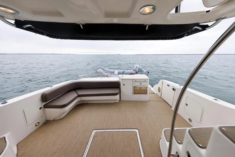 Slide: The Image of 2010 Sea Ray 520 Sedan Bridge yacht deck with seating and ocean view. - 32