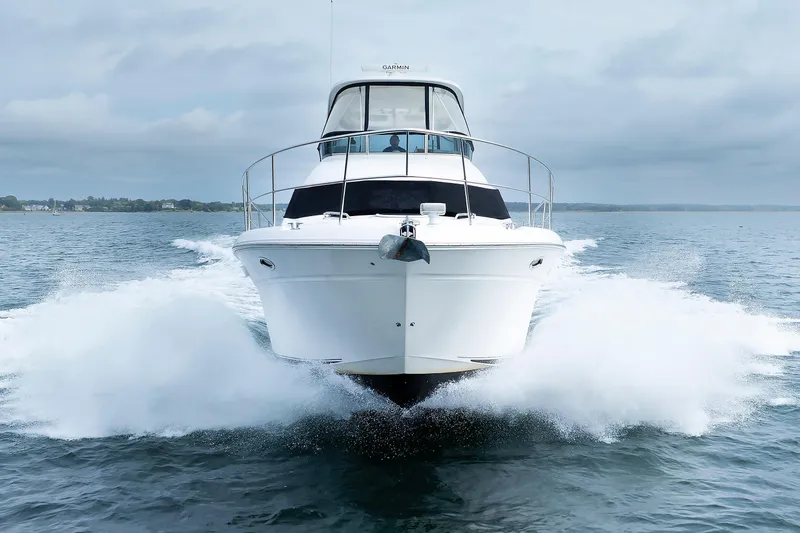 Slide: The Image of 2010 Sea Ray 520 Sedan Bridge cruising on open water, front view. - 4