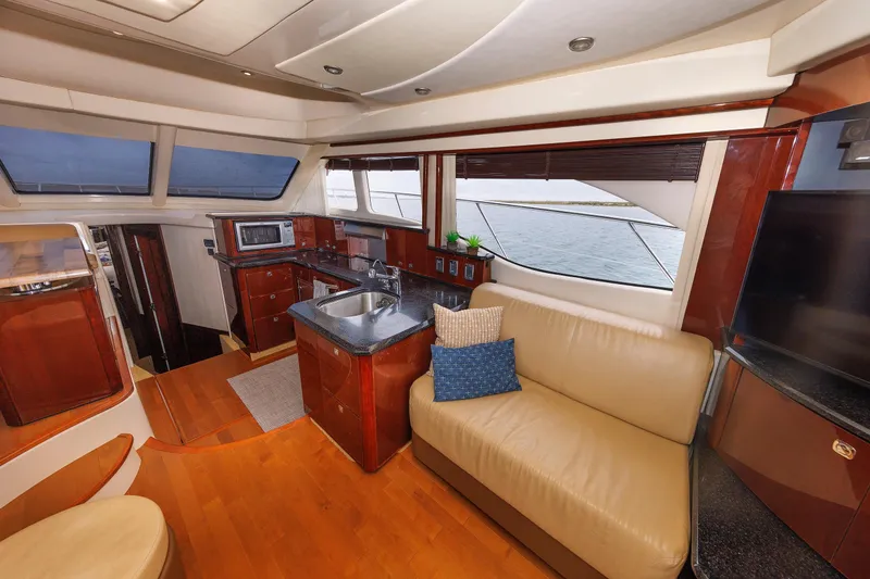 Slide: The Image of Luxurious interior of 2010 Sea Ray 520 Sedan Bridge yacht with modern kitchen and seating area. - 42