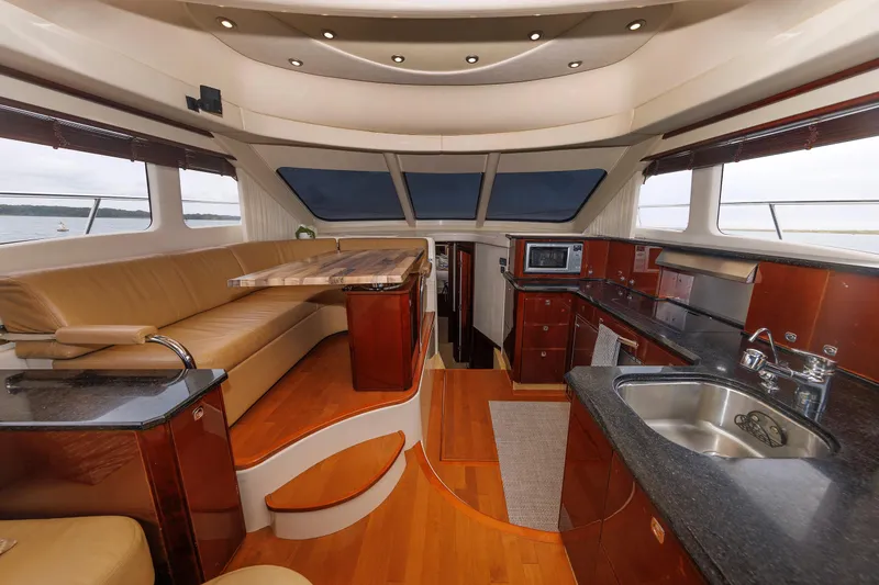 Slide: The Image of Luxurious interior of 2010 Sea Ray 520 Sedan Bridge yacht with modern kitchen and seating area. - 43