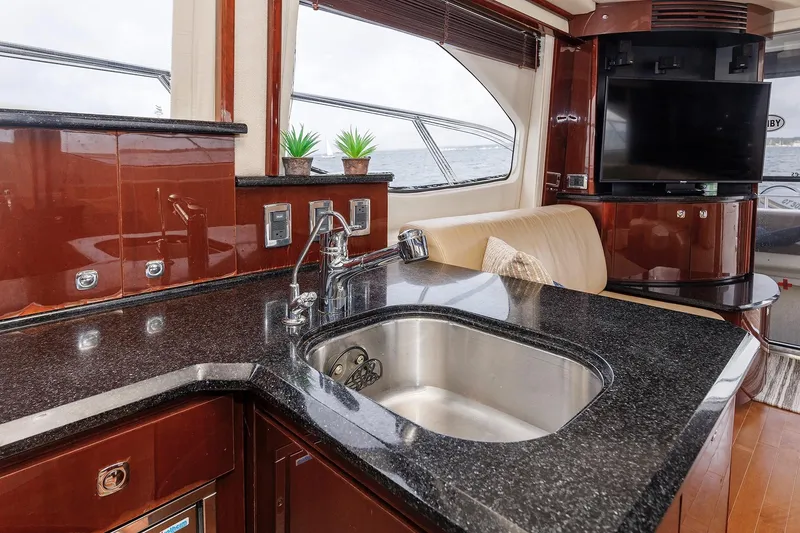 Slide: The Image of Luxurious 2010 Sea Ray 520 Sedan Bridge yacht interior with sleek kitchen and modern amenities. - 46
