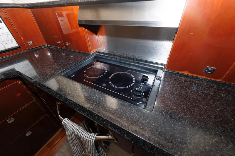 Slide: The Image of Modern kitchen in 2010 Sea Ray 520 Sedan Bridge yacht with electric stovetop. - 47