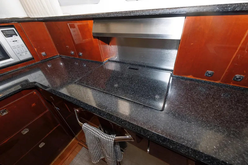 Slide: The Image of Luxurious kitchen in 2010 Sea Ray 520 Sedan Bridge yacht with sleek countertops. - 49