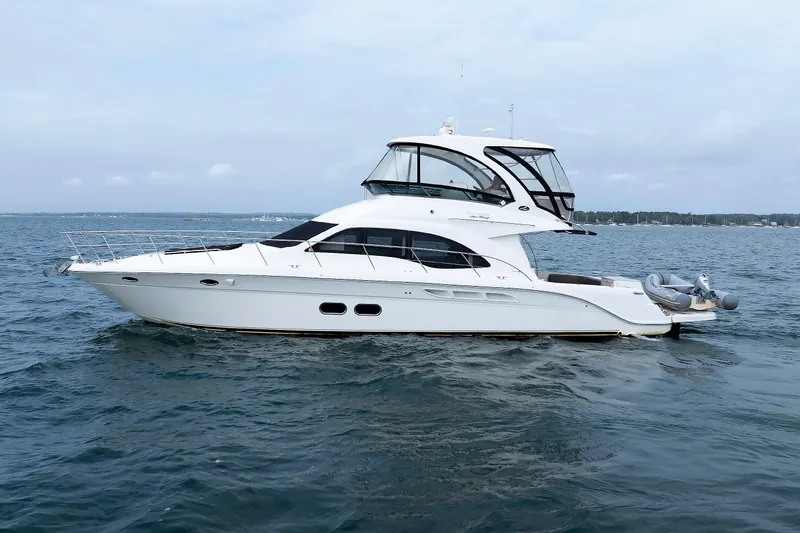 Slide: The Image of 2010 Sea Ray 520 Sedan Bridge yacht cruising on open water. - 5