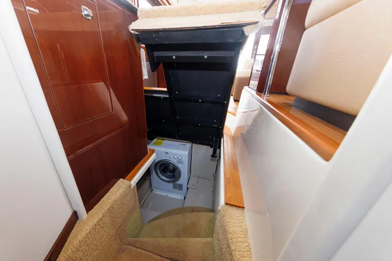Slide: The Image of 2010 Sea Ray 520 Sedan Bridge interior with hidden laundry area and wooden finishes. - 50