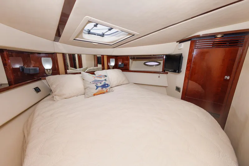 Slide: The Image of Luxurious bedroom interior of 2010 Sea Ray 520 Sedan Bridge yacht with plush bedding. - 54