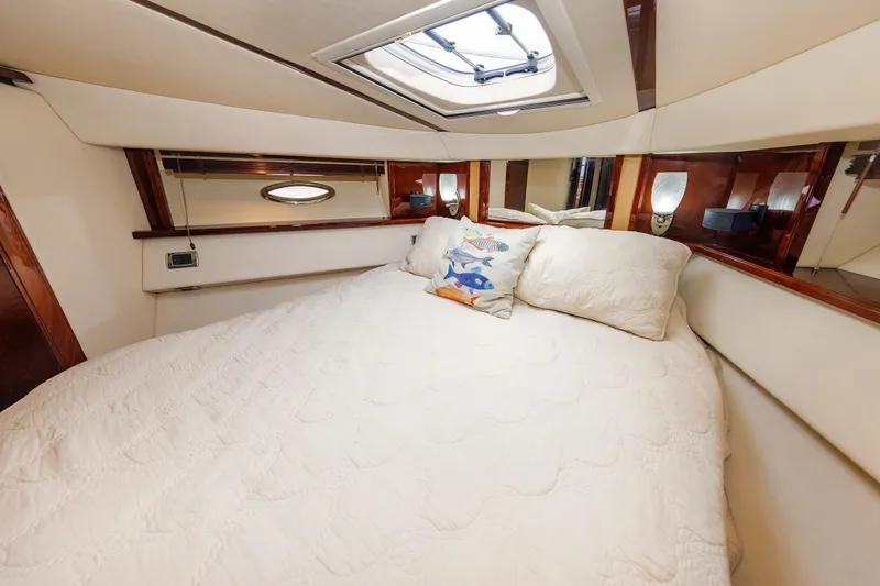 Slide: The Image of Luxurious bedroom interior of 2010 Sea Ray 520 Sedan Bridge yacht with plush bedding. - 55