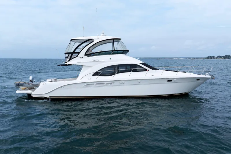 Slide: The Image of 2010 Sea Ray 520 Sedan Bridge yacht on open water, side view. - 6