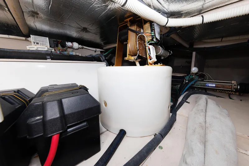 Slide: The Image of Engine room of 2010 Sea Ray 520 Sedan Bridge with mechanical components and wiring. - 62
