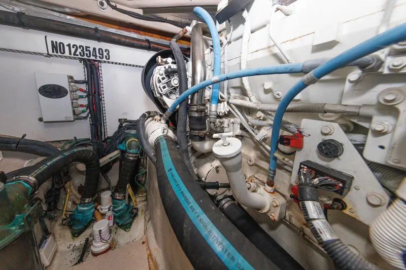 Slide: The Image of Engine room of 2010 Sea Ray 520 Sedan Bridge with visible pipes and wiring. - 66