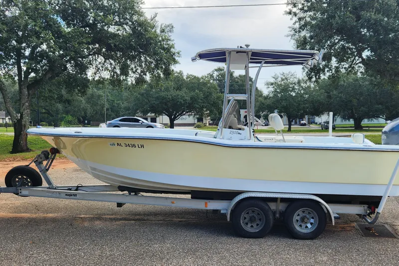 Slide: The Image of 2005 Polar 2310 Bay boat on trailer, parked outdoors with trees in background. - 1