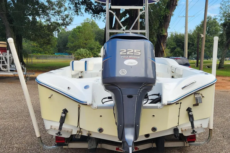 Slide: The Image of 2005 Polar 2310 Bay boat with 225 four-stroke engine, parked outdoors. - 2