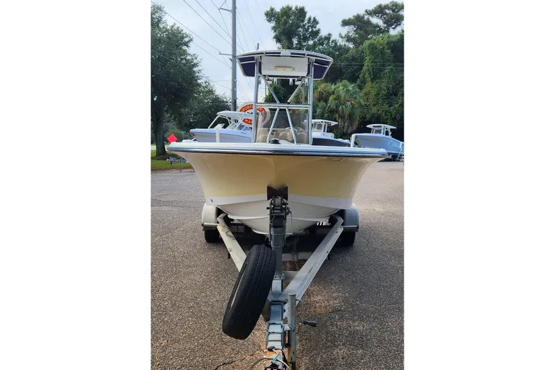 Slide: The Image of 2005 Polar 2310 Bay boat on trailer, parked outdoors with trees in background. - 3