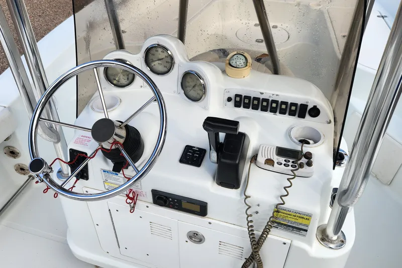 Slide: The Image of 2005 Polar 2310 Bay boat console with steering wheel, gauges, and communication equipment. - 7