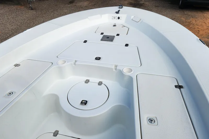 Slide: The Image of 2005 Polar 2310 Bay boat deck with storage compartments and clean white finish. - 8