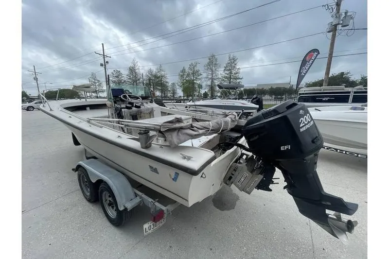 Slide: The Image of 1973 Wellcraft 200 Fisherman boat on trailer under cloudy sky. - 2