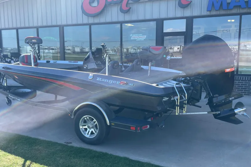 Slide: The Image of 2018 Ranger Z185 boat displayed outside a marine dealership. - 1