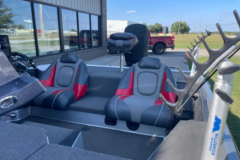 Slide: The Image of 2018 Ranger Z185 boat interior with red and gray seats, rod holders, and steering console. - 3