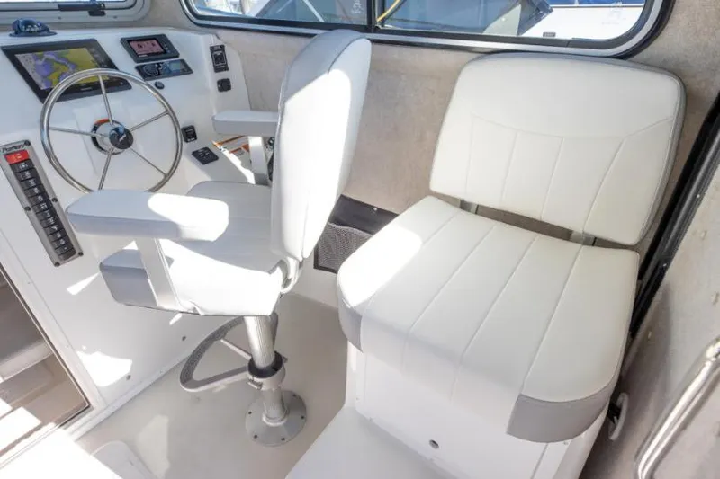 Slide: The Image of Manufacturer Provided Image: 2022 Parker 2520 XLD Sport Cabin interior with helm and passenger seats. - 12